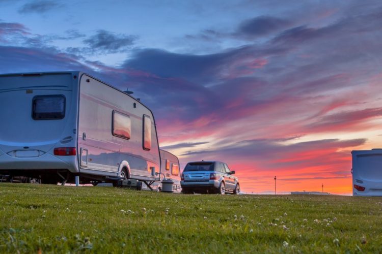 Car and caravan on campsite